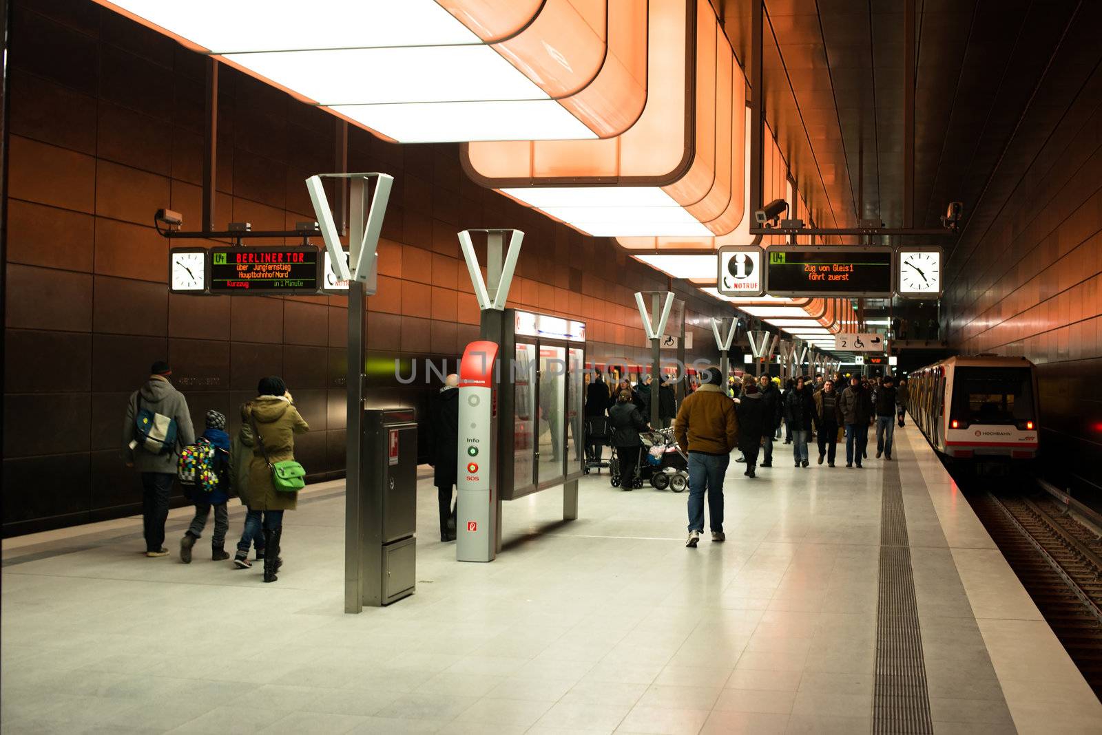 HAMBURG - DECEMBER 2, 2012: First passengers are using the new underground station “Hafencity University” in Hamburg Hafencity on December 2, 2012 in Hamburg Germany. The station connects the exciting newly built area of Hafencity with the rest of Hamburg – currently the public can test drive the line for free before the station is officially connected with the timetable of the underground.