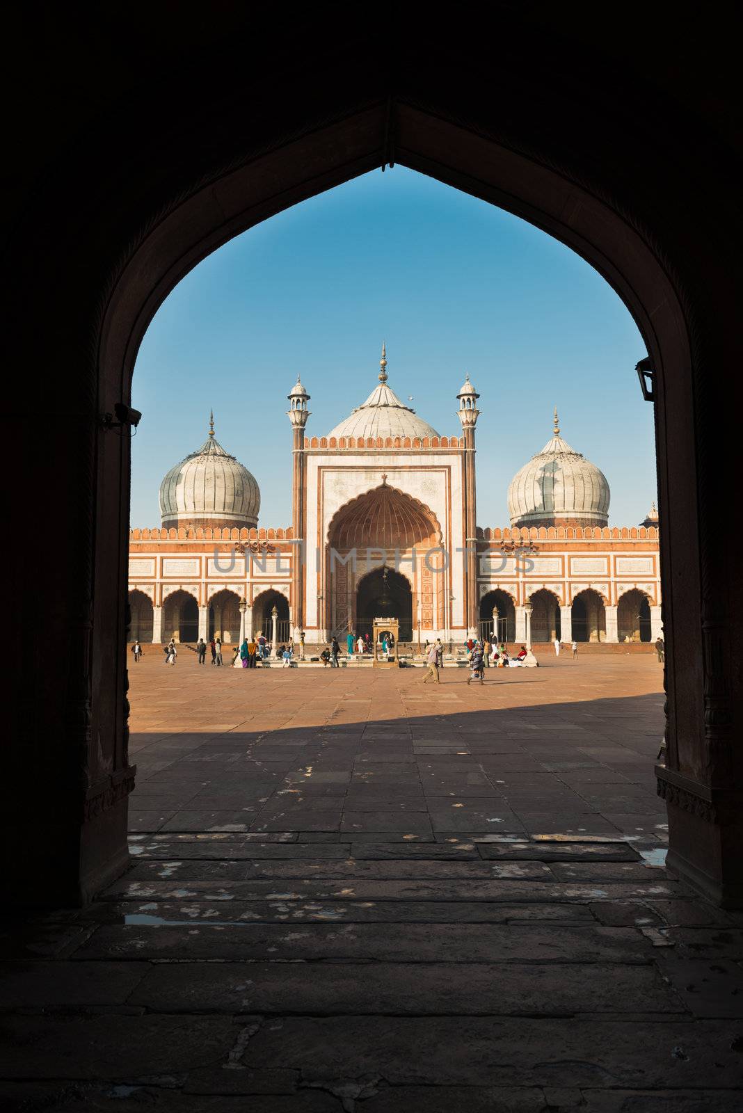 DELHI, INDIA - DECEMBER 1: people walks in the courtyard of Jama Masjid, a major tourist attraction and the largest and best known mosque in india on Dec 01, 2012 in Delhi, India 