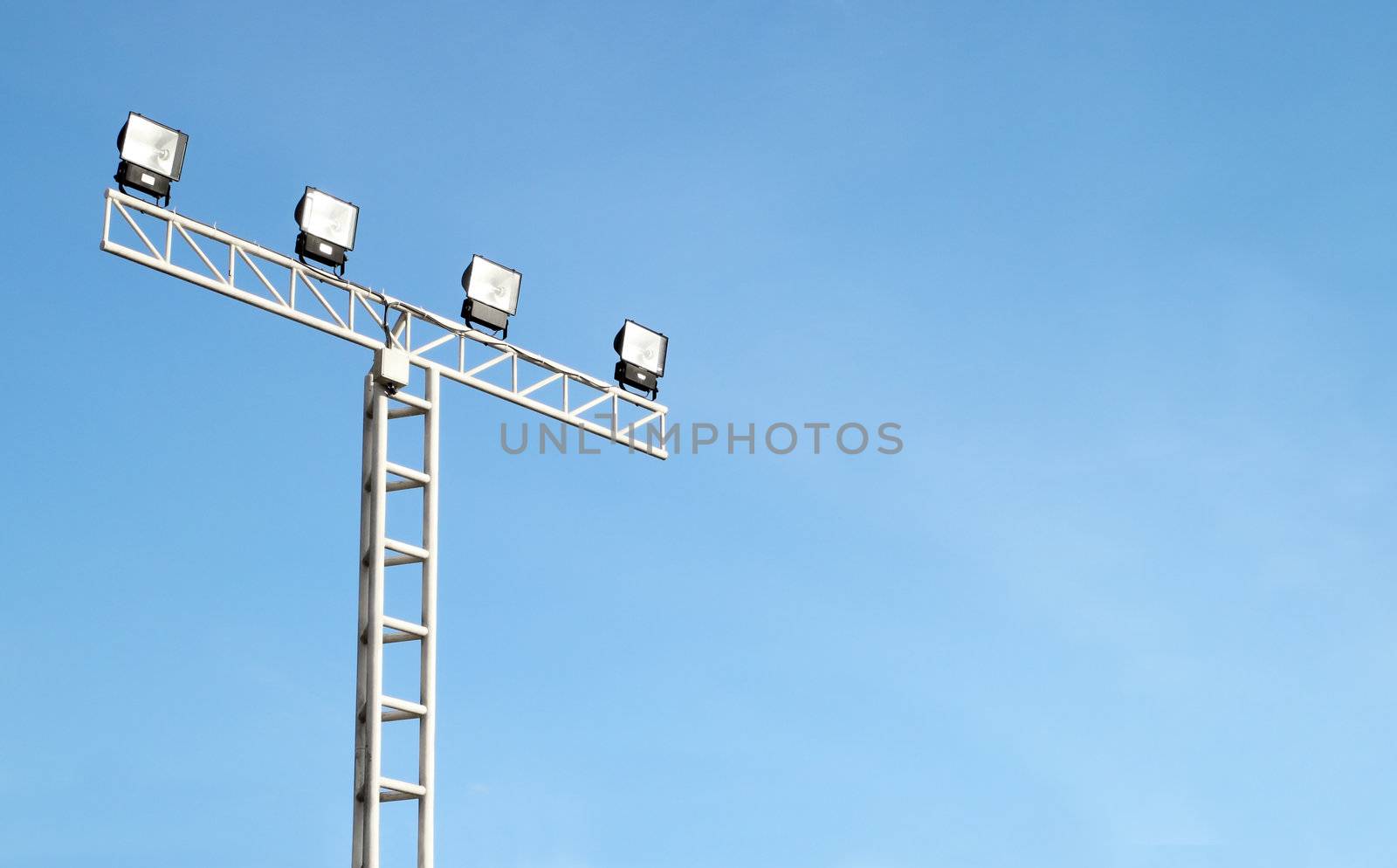 Spot light pole with blue sky