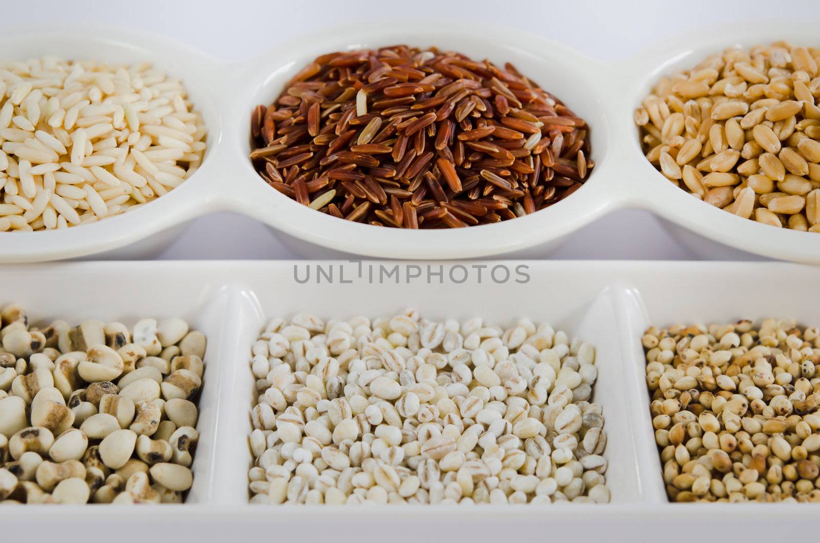 Grain and Cereal Set ,  rice , red rice , wheat,  job's tears , barley and millet grains on white bowl
