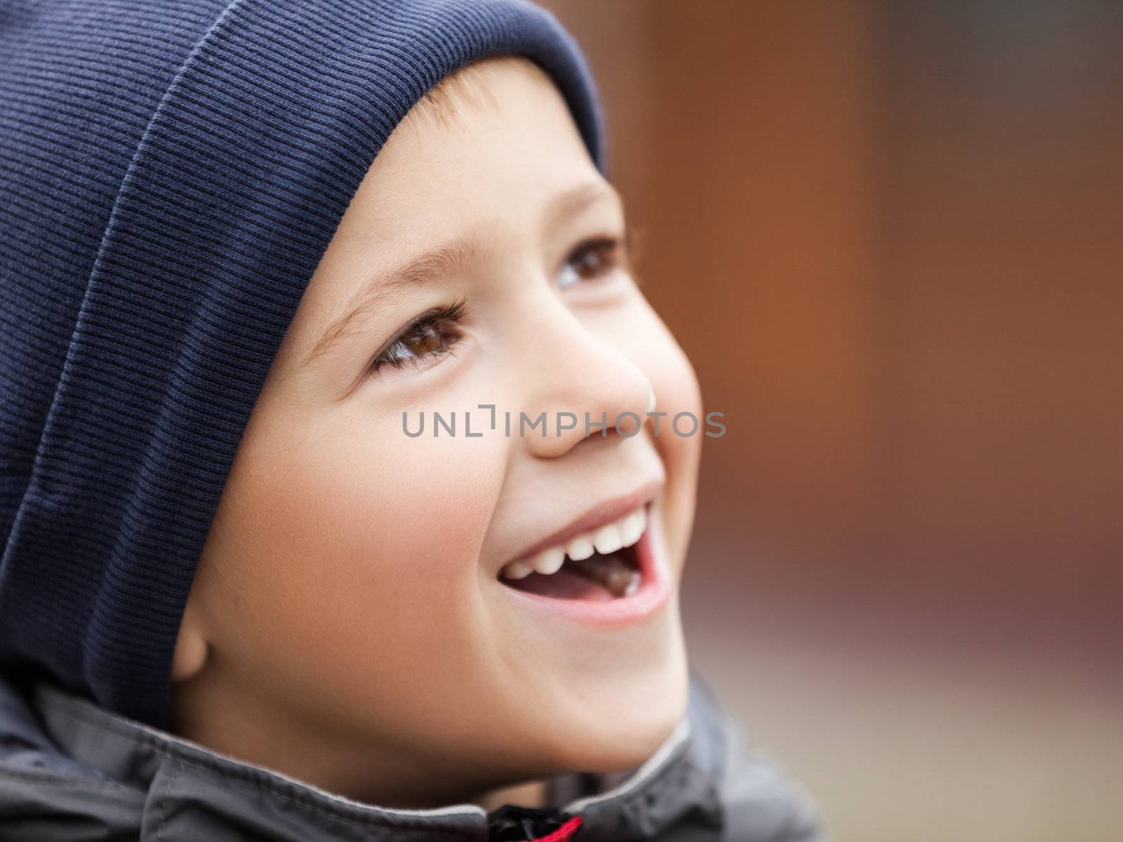 Little cheerful child boy walking outdoor and smiling for happiness and fun