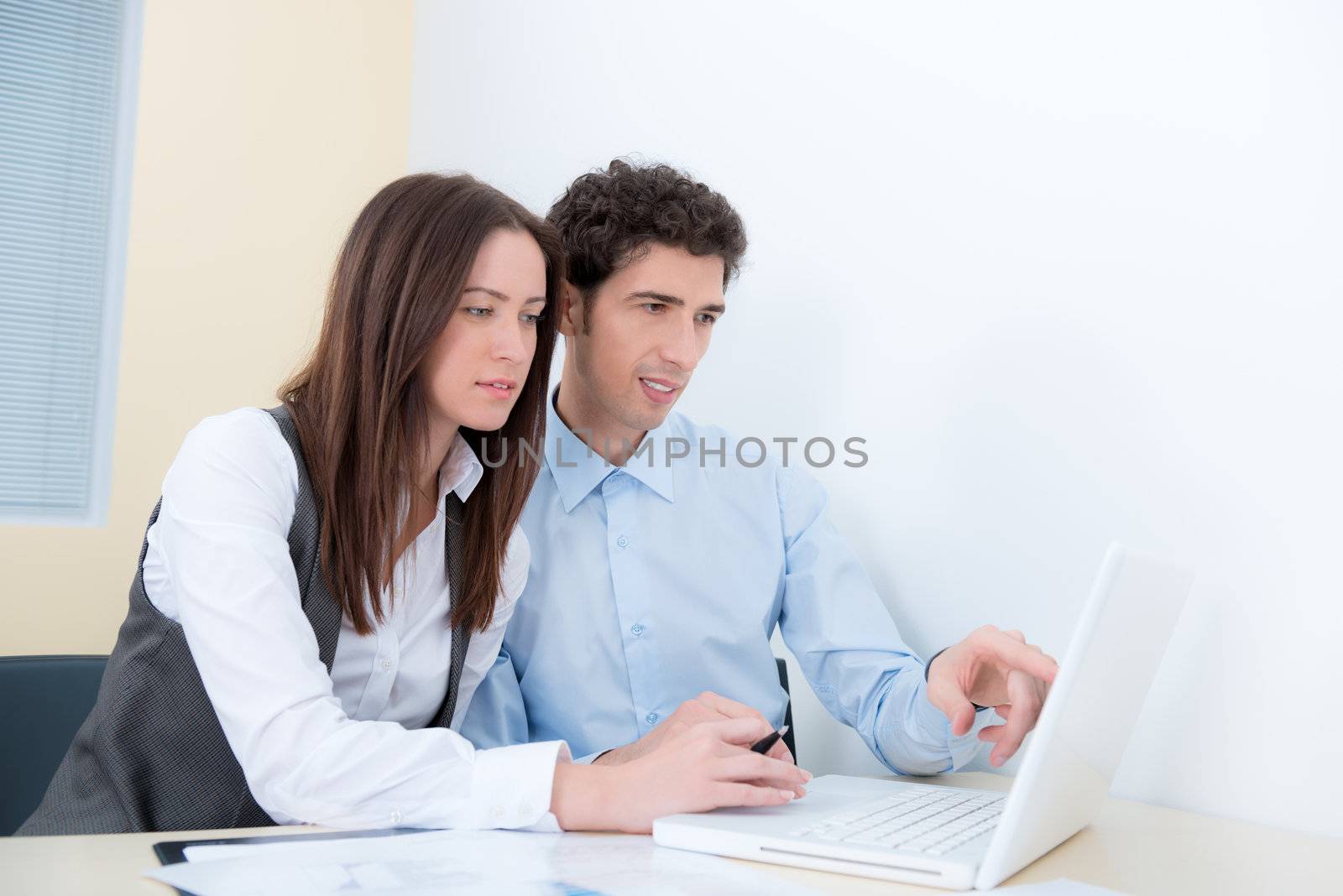 A business team are planning and discuss the project with a modern laptop.