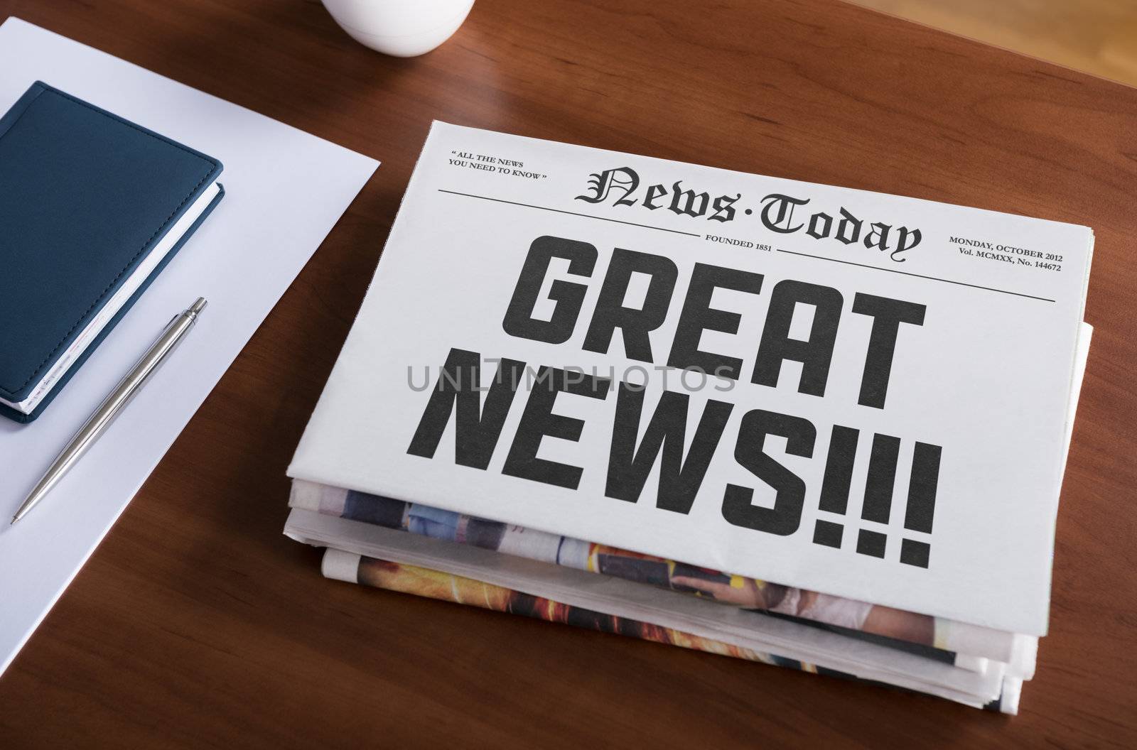 Newspaper with hot topic "Great news" lying on office desk.