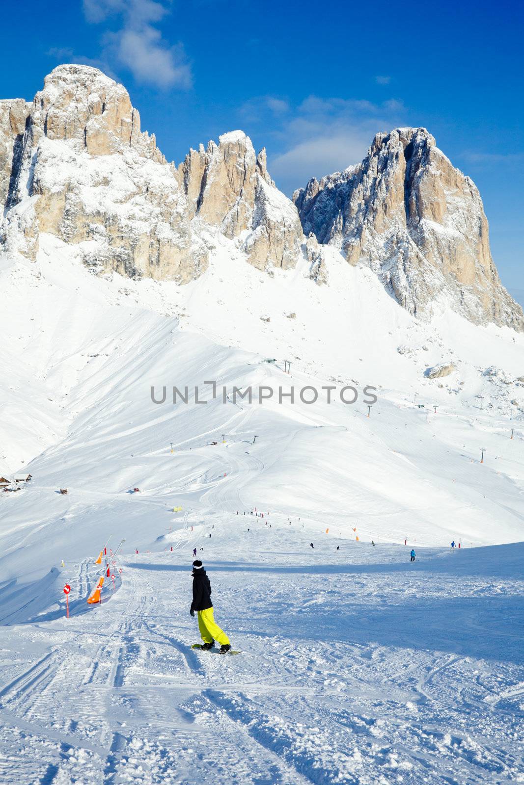 Snowborder going down the slope at Val Di Fassa ski resort in Italy