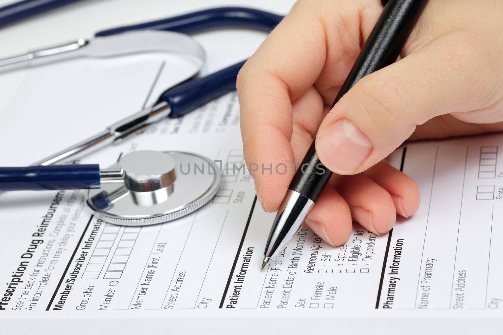 Hand with pen over blank Prescription form with patient information