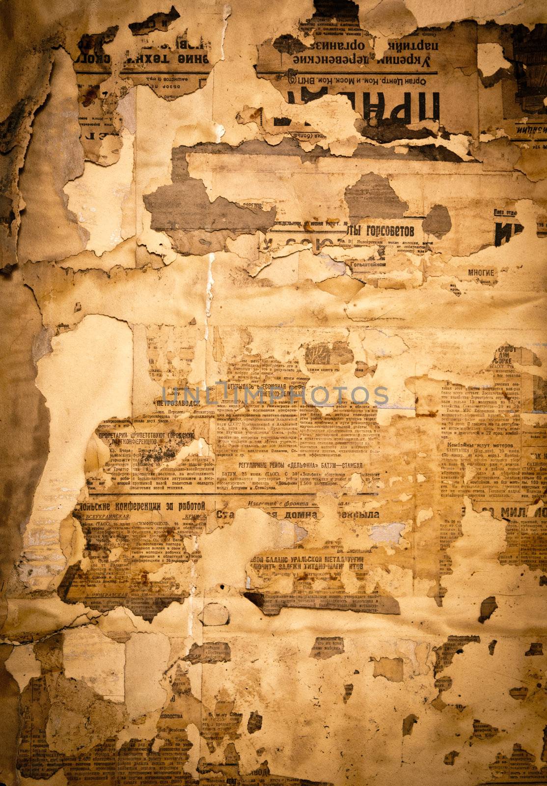 Grungy background with old yellowed Soviet newspaper fragments