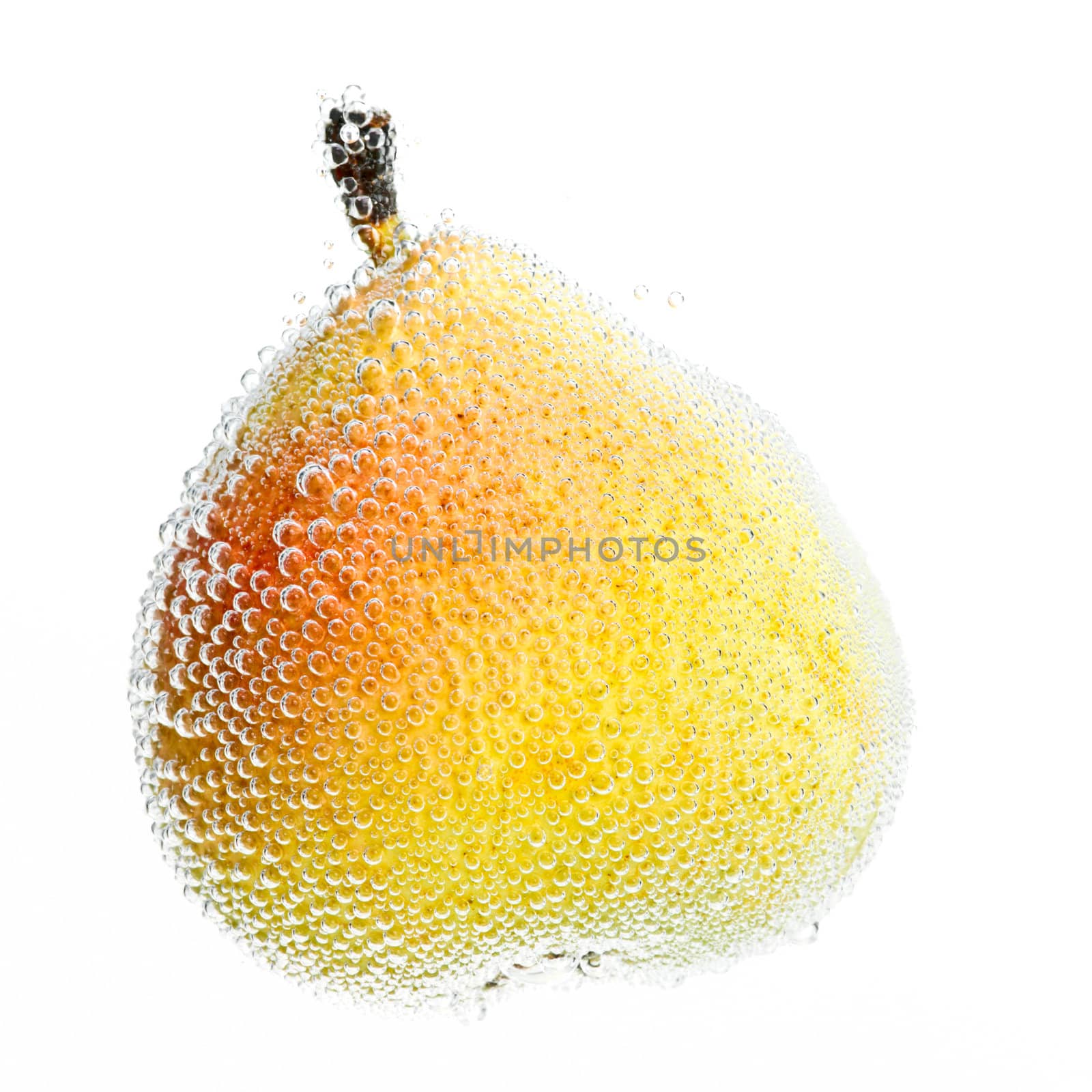 Single pear in water with bubbles on white background