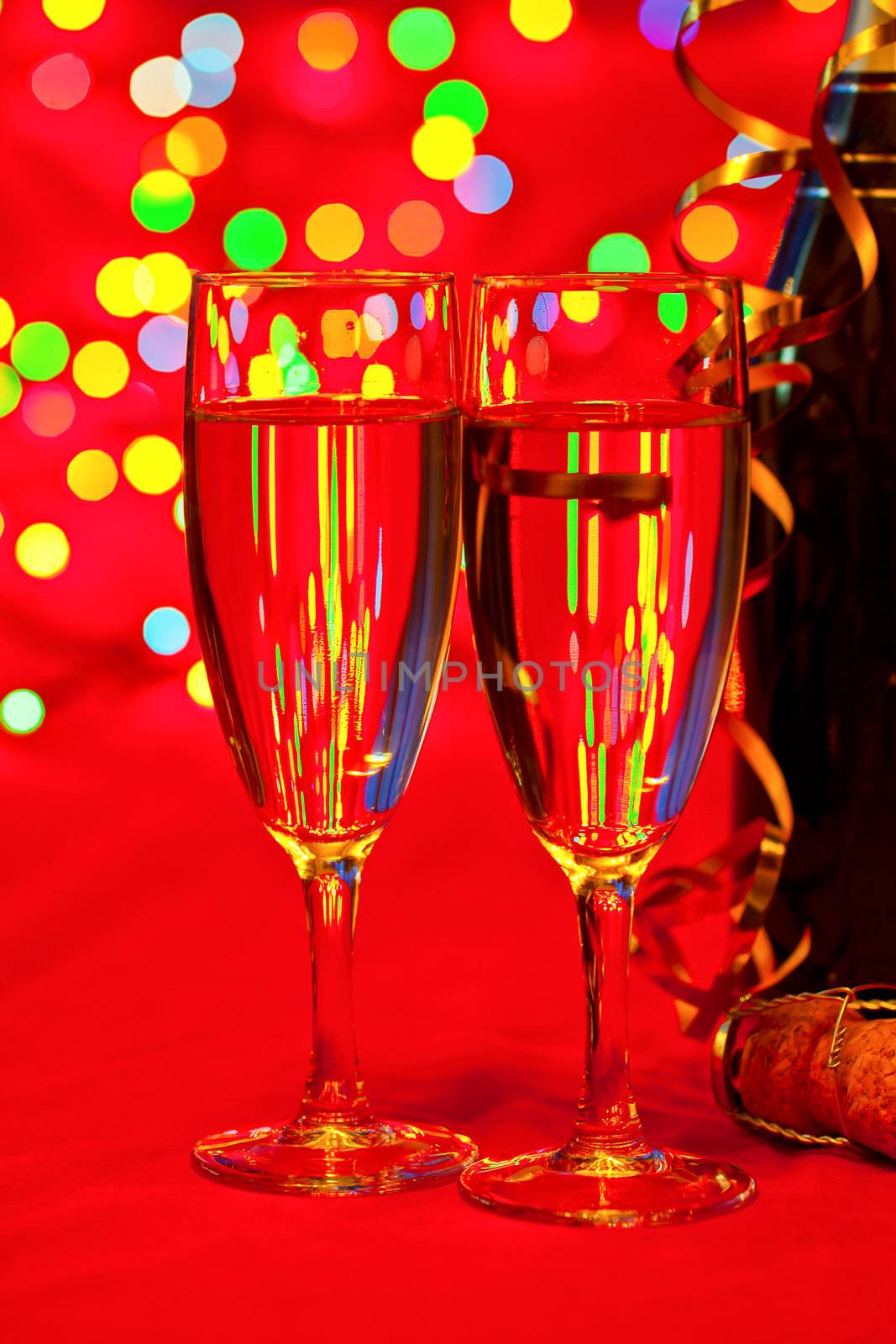 Two glasses of champagne with blured lights in background