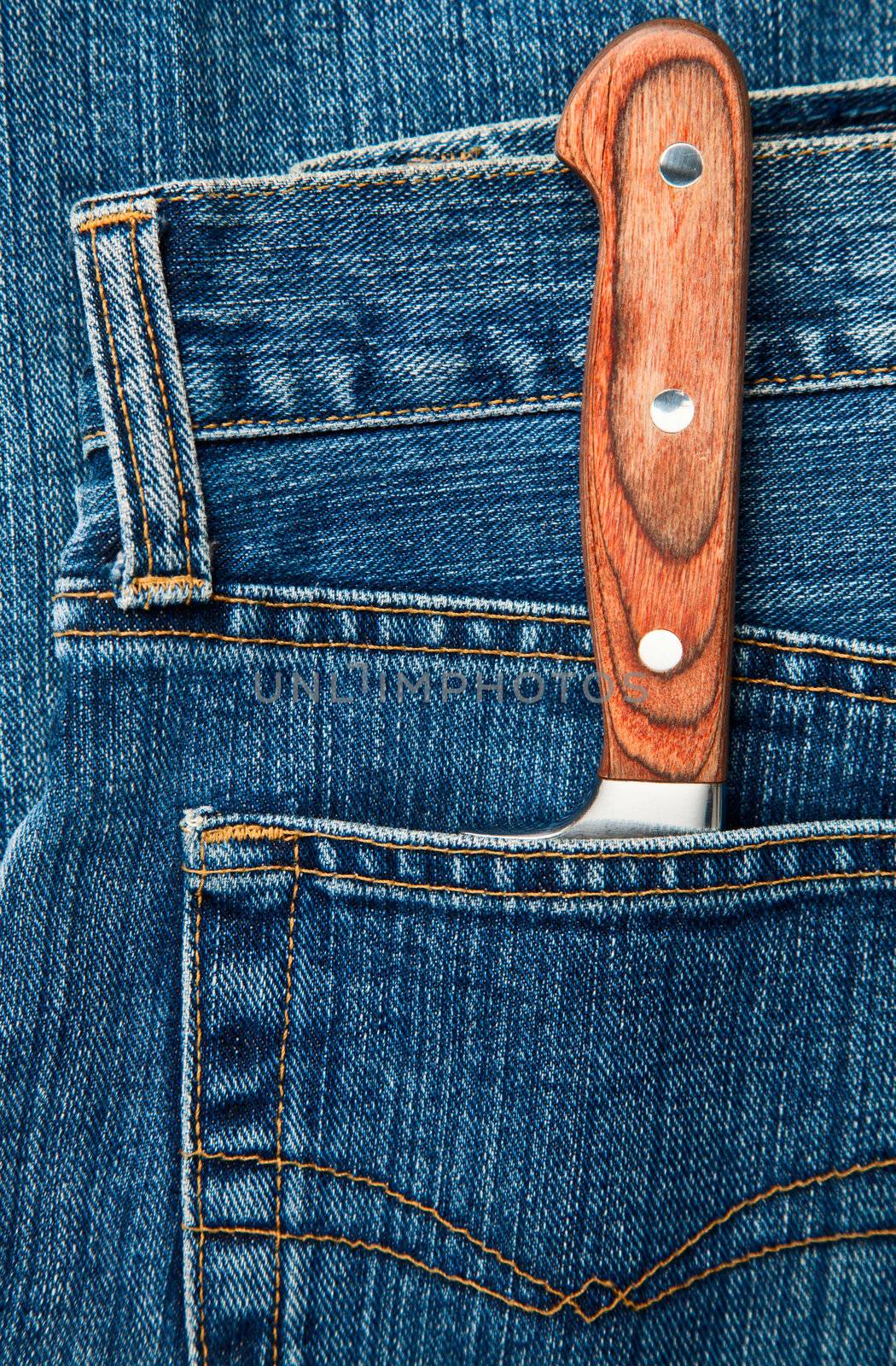 Blue jeans pocket with kitchen knife