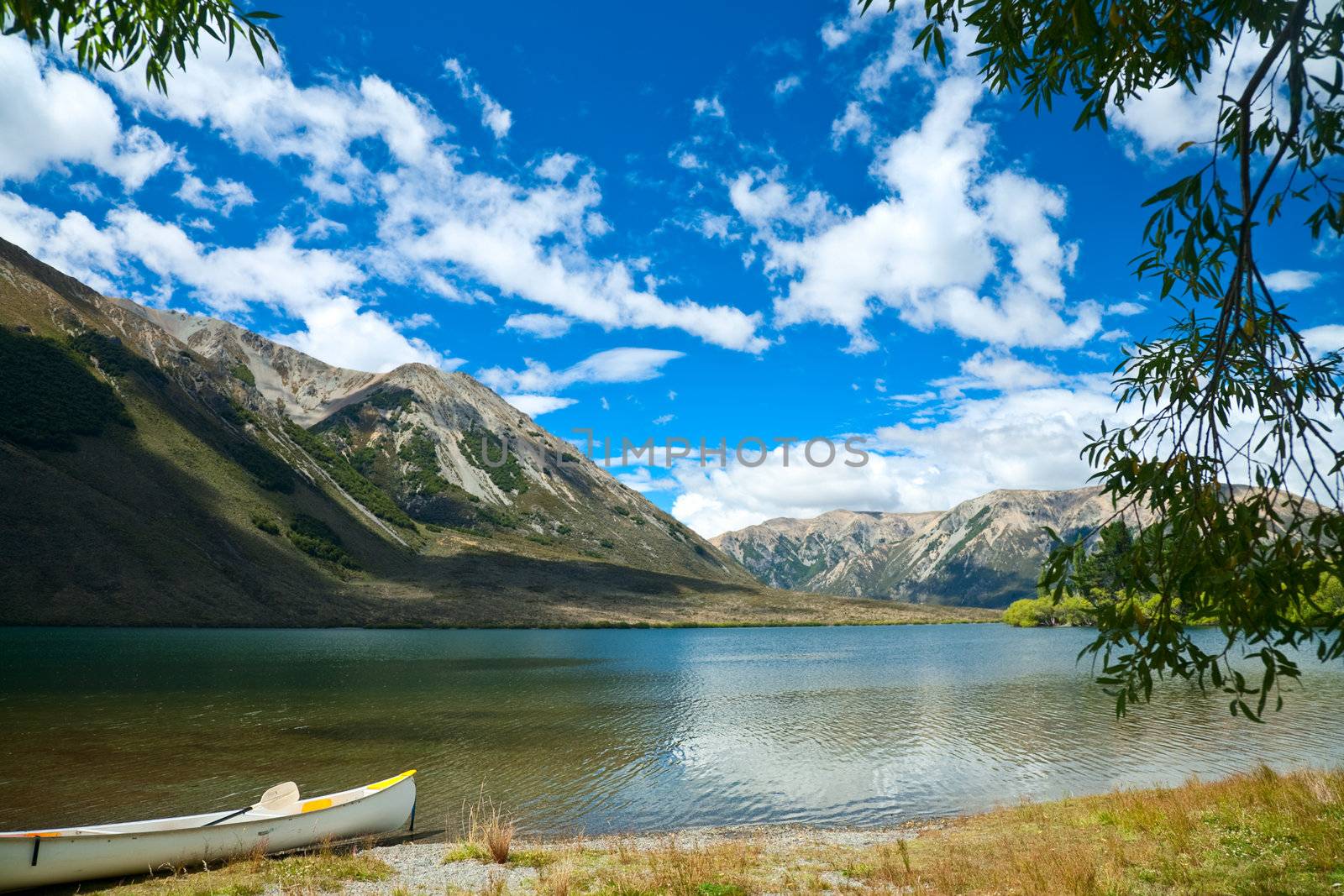 Touring canoe on a mountain lake shoreline