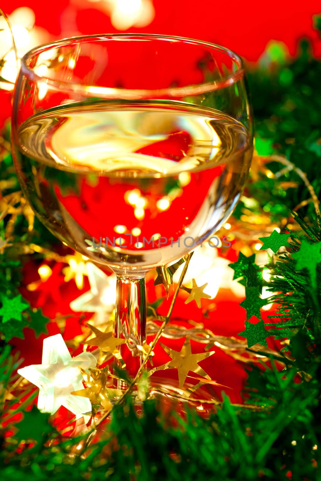 Glass of white wine with Christmas decoration, very shallow DOF