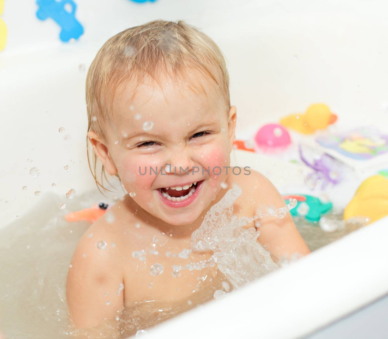 Cute little girl enjoys bathing