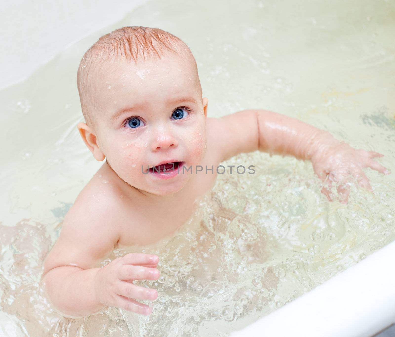 Cute little baby girl bathing