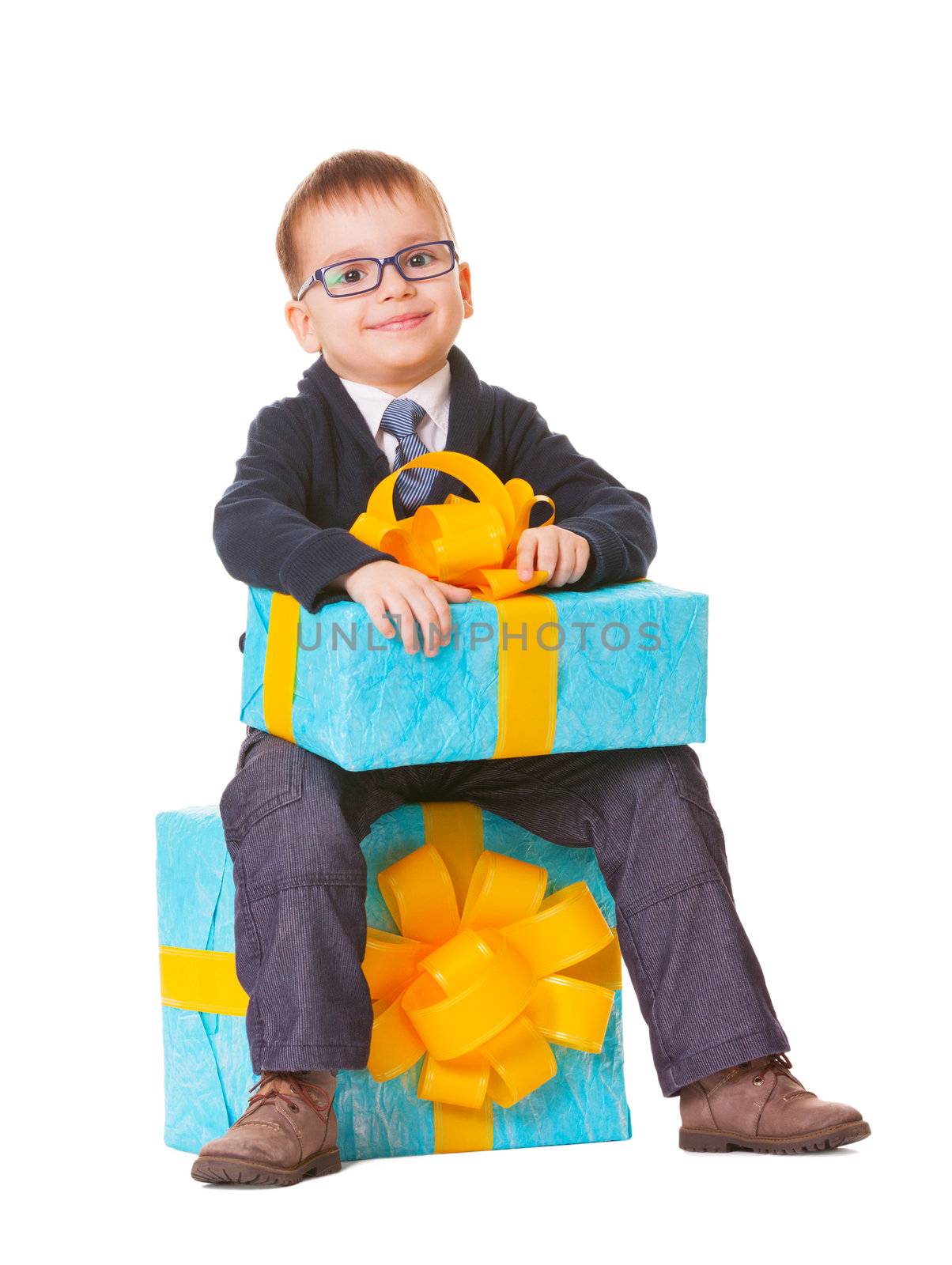 Small boy in spectecles with two big presents on white background