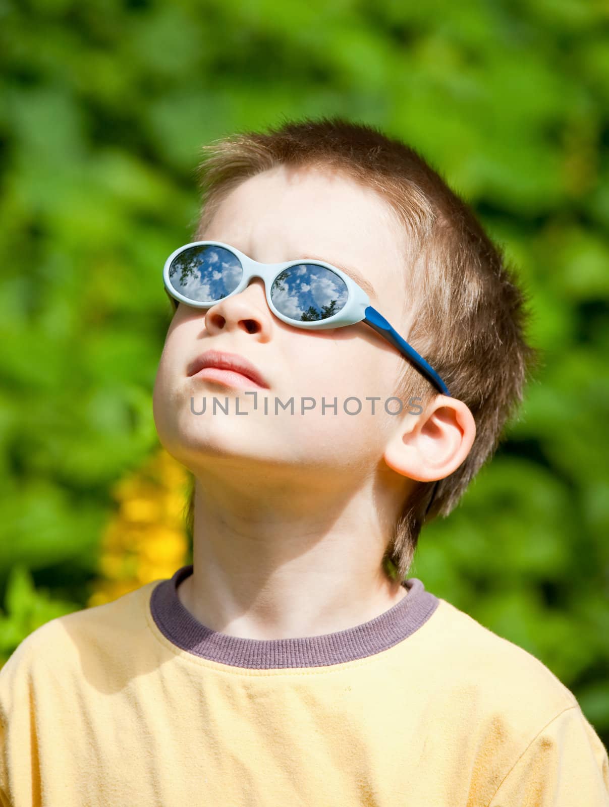 Portrait of a young boy wearing sunglasses outdoors