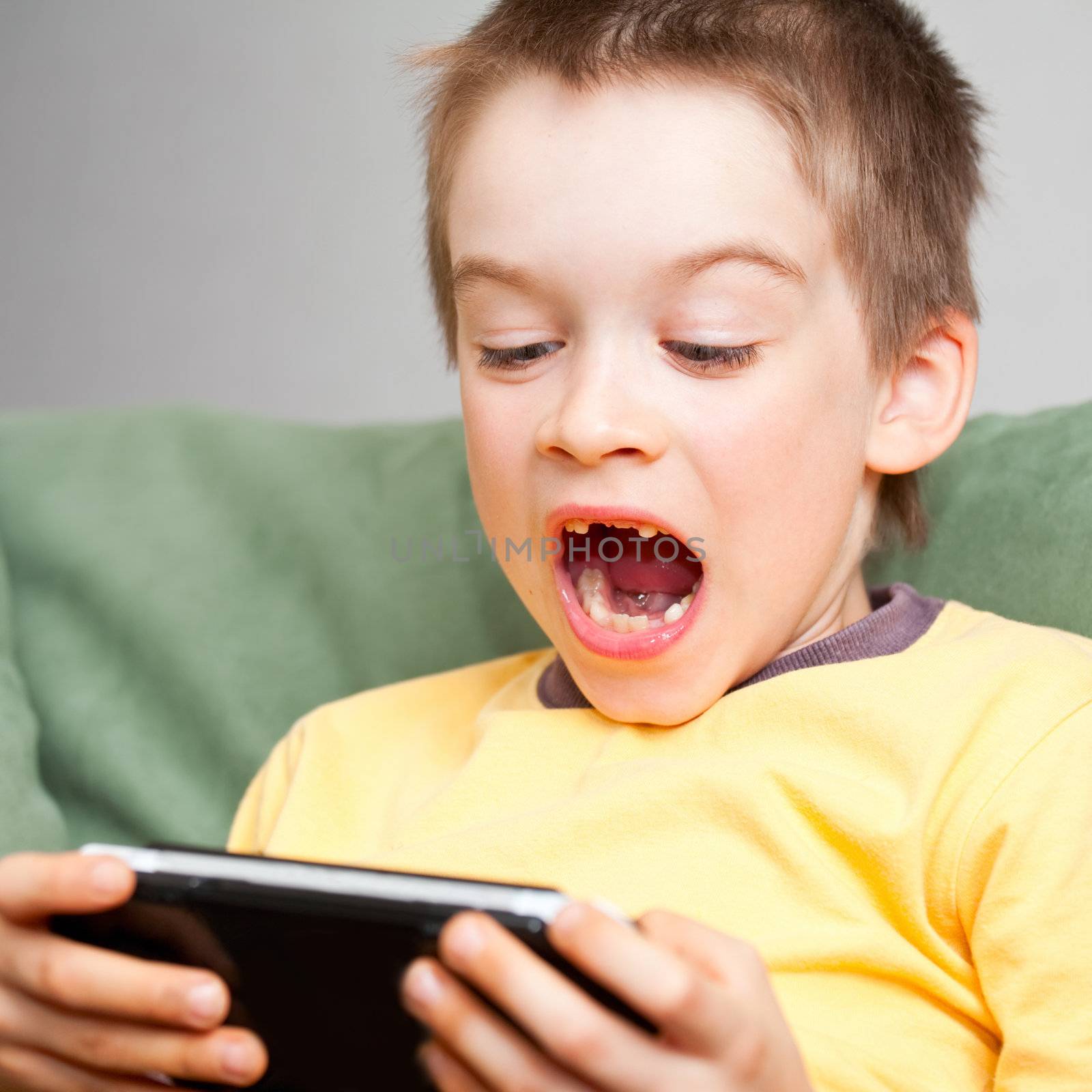 Boy playing game console by naumoid