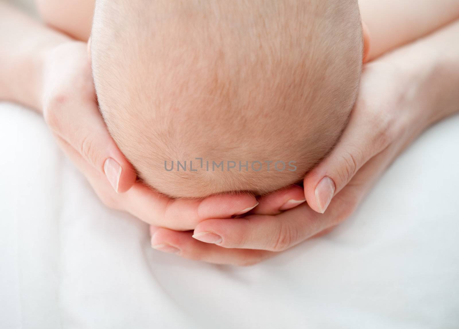 Mother holding her child's head, shallow DOF