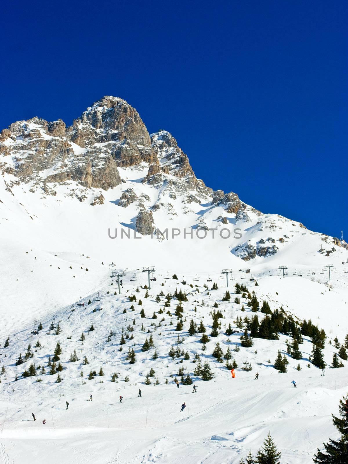 Skiers on a piste at Alpine ski resort