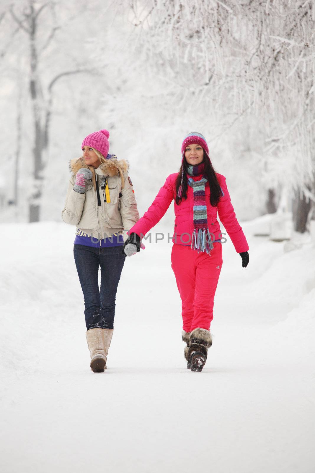 two winter women run by snow frosted alley