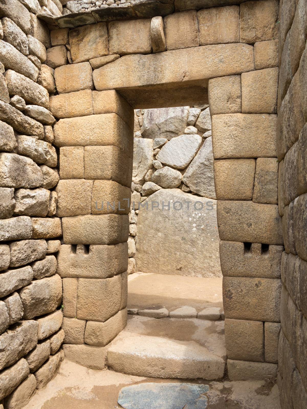 Morning views of Machu Picchu with detail of doorway in city