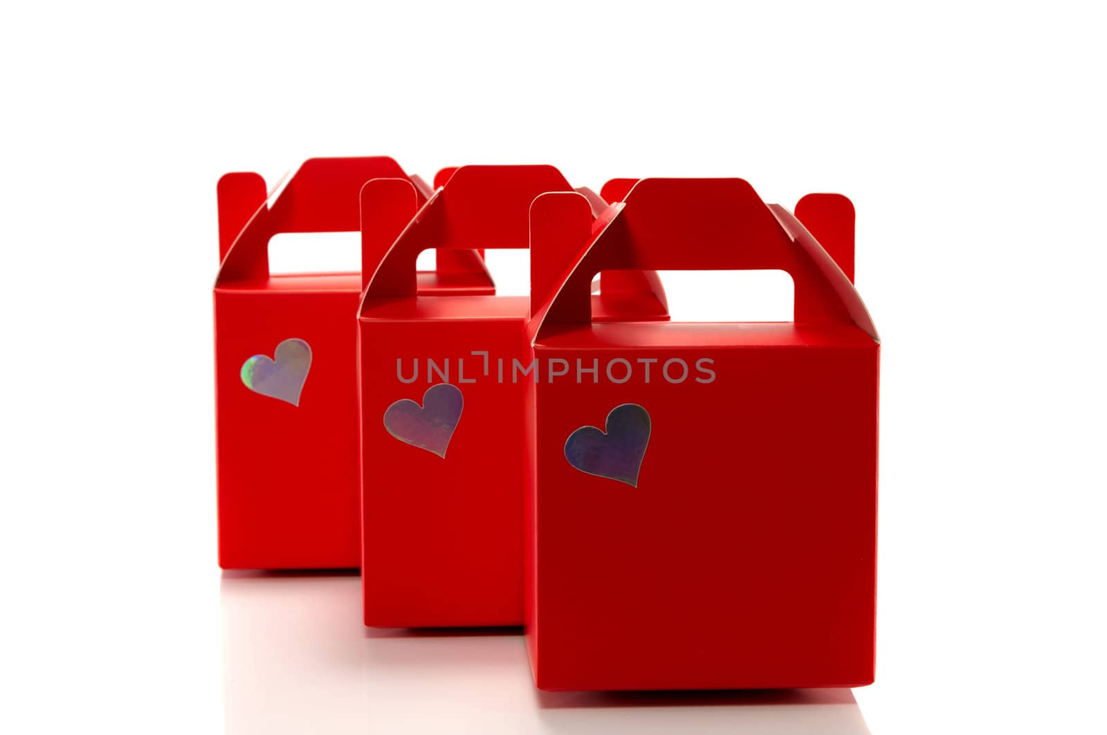 three red gift boxes isolated on white