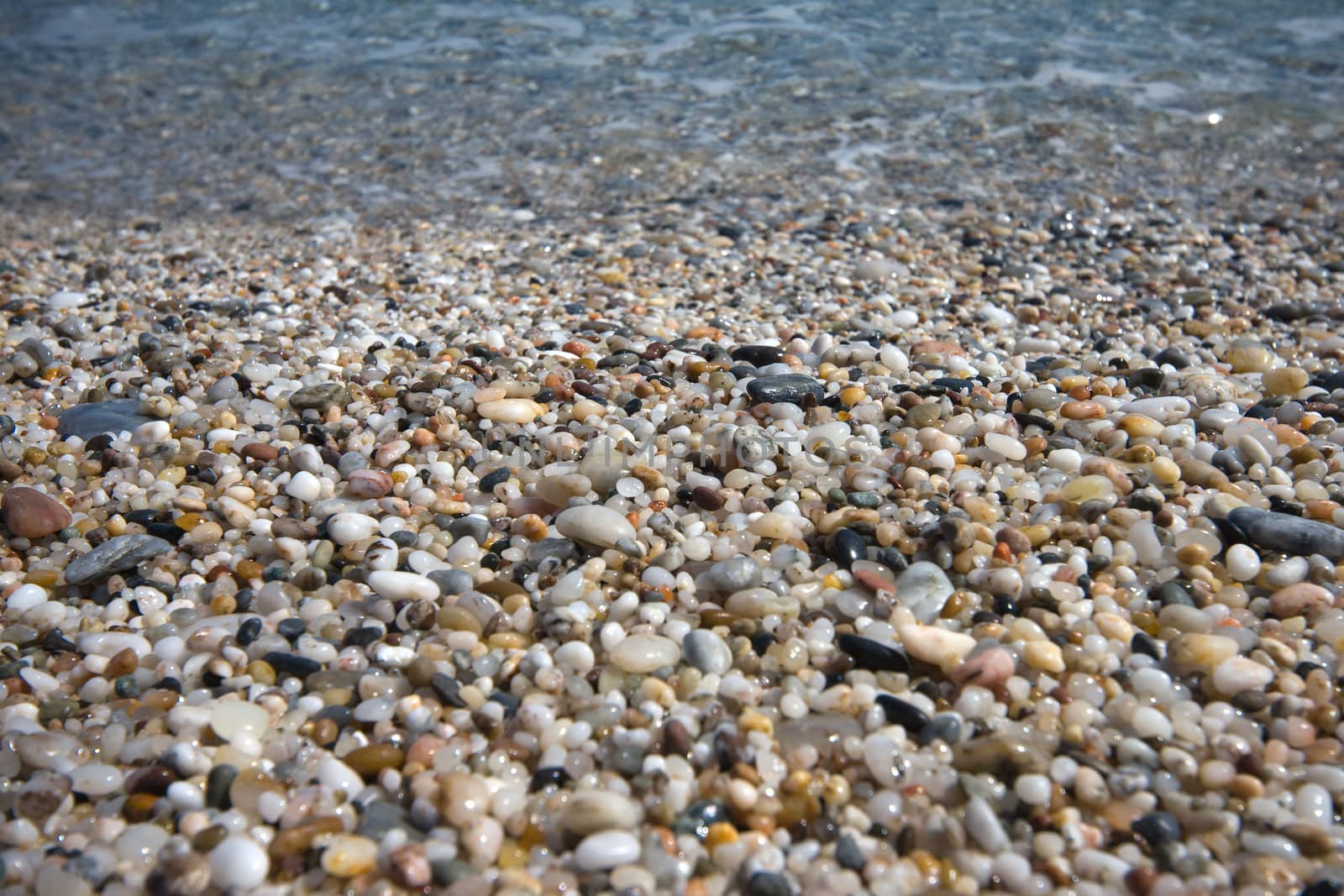 small pebbles in beach of the Mediterranean Sea, in Spain