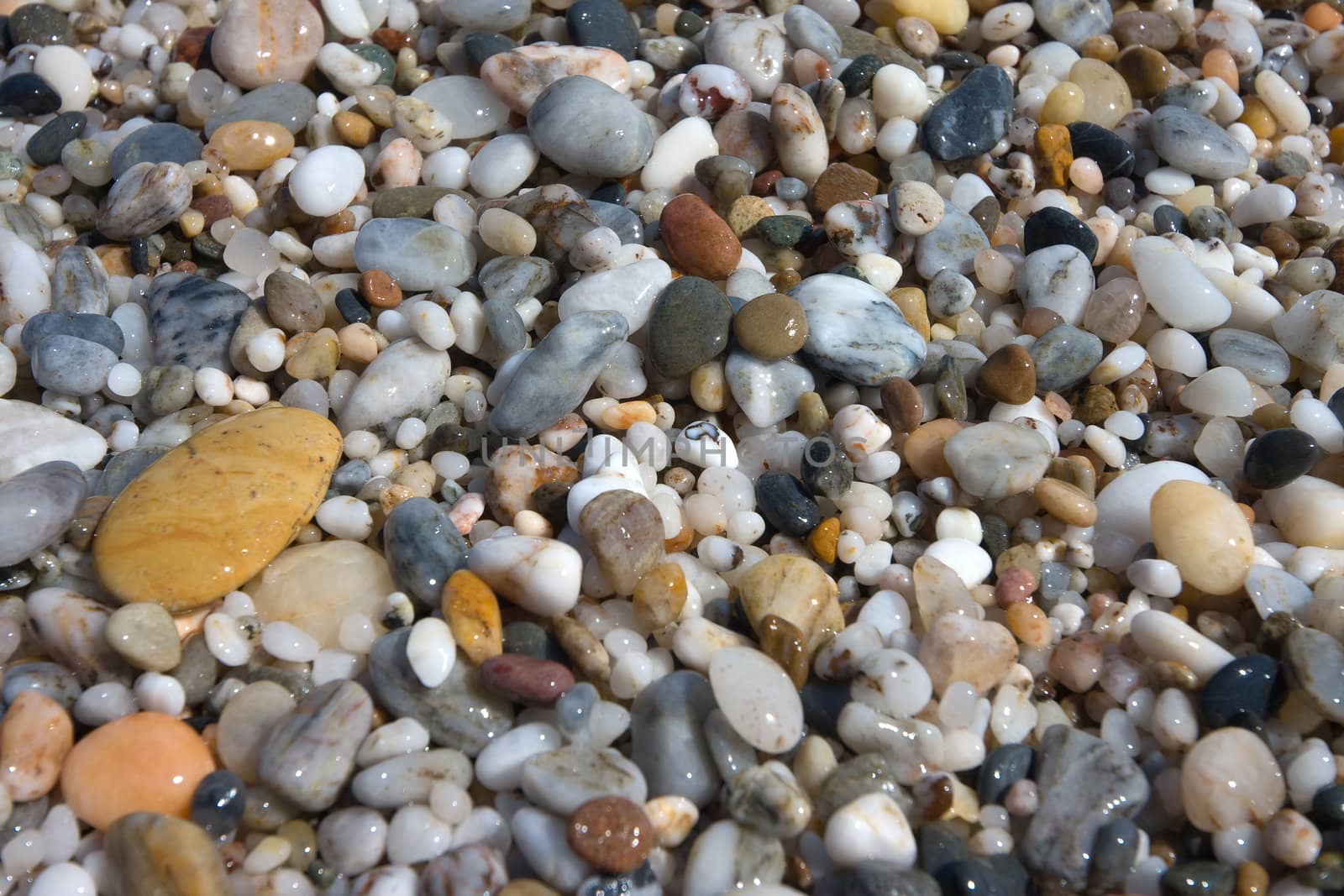 small pebbles in beach of the Mediterranean Sea, in Spain