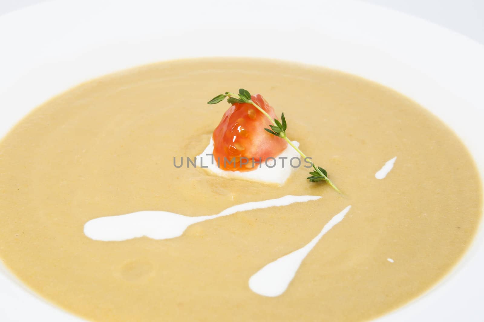 pea puree soup with goat cheese and tomatoes