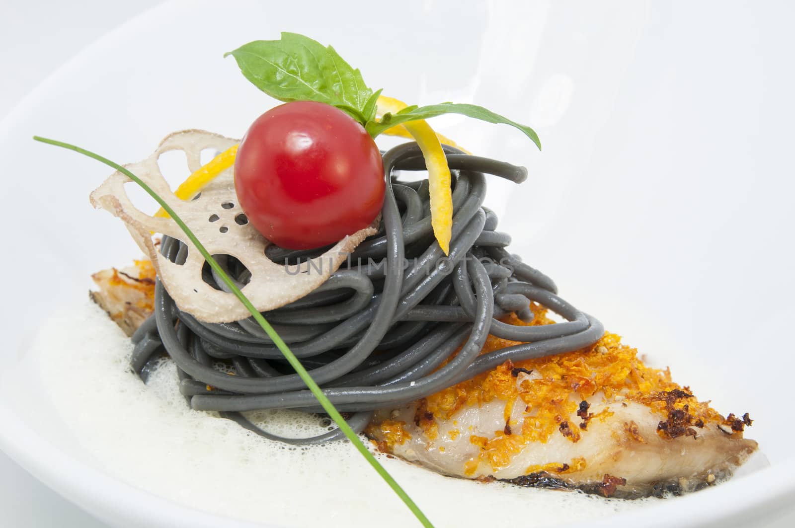 baked fish with black and white spaghetti sauce