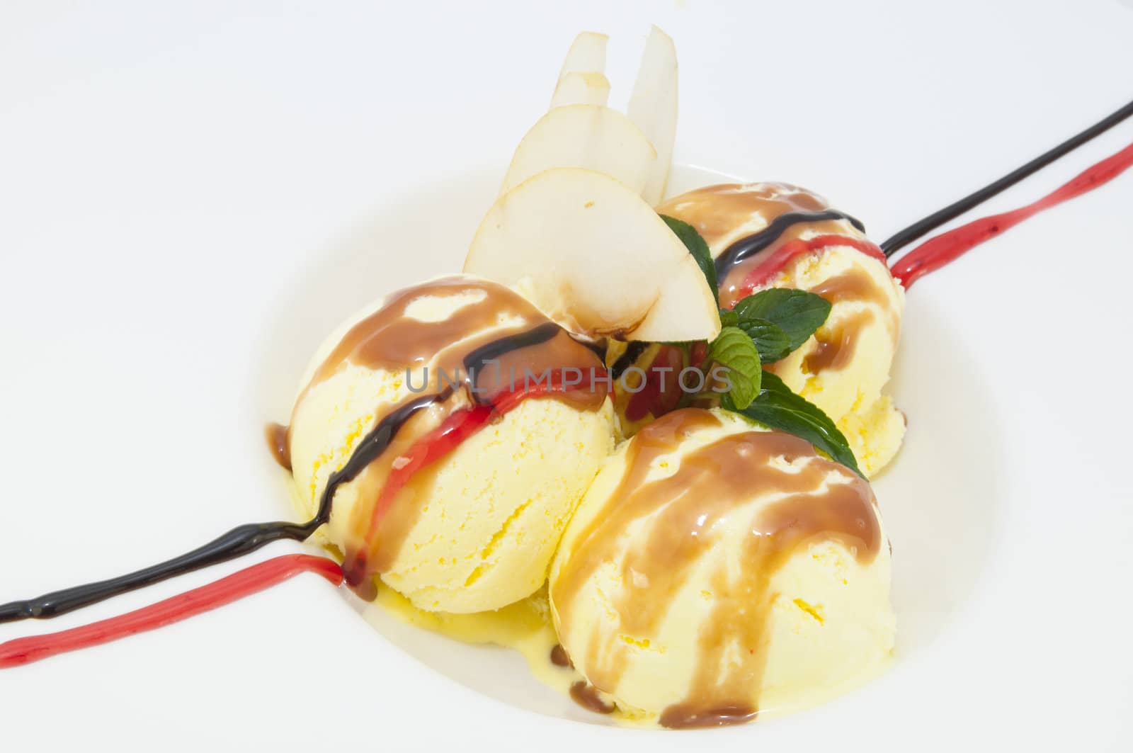 balls of ice cream decorated with mint on a white background in the restaurant