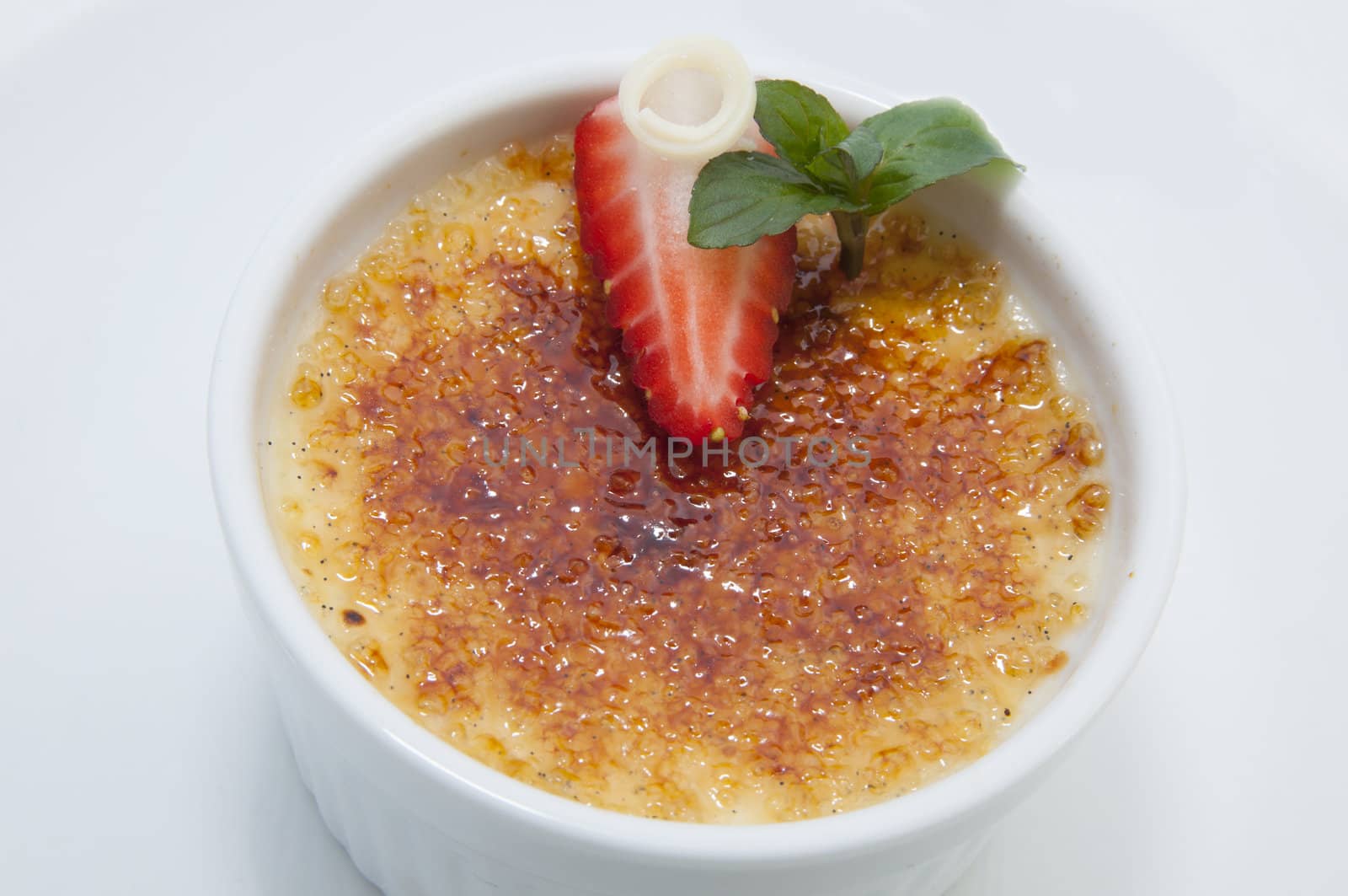 portion of the cream brulee on a white background