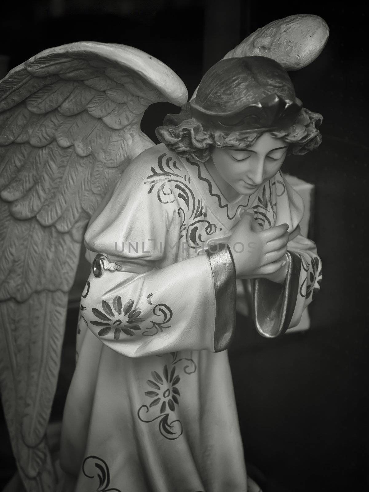 Antique angel figure in shop window display - Orviedo, Spain. Monochrome.