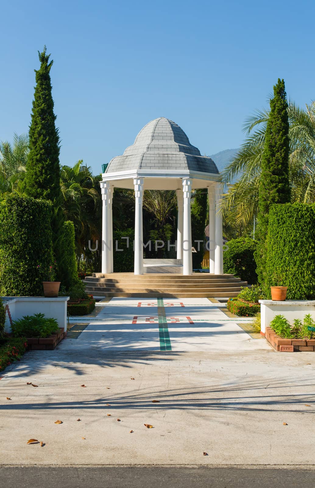 pavilion in garden with blue sky by moggara12