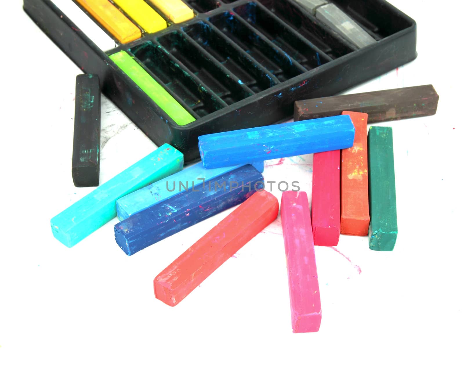 Multicolored artist's pastels (chalk) on white background