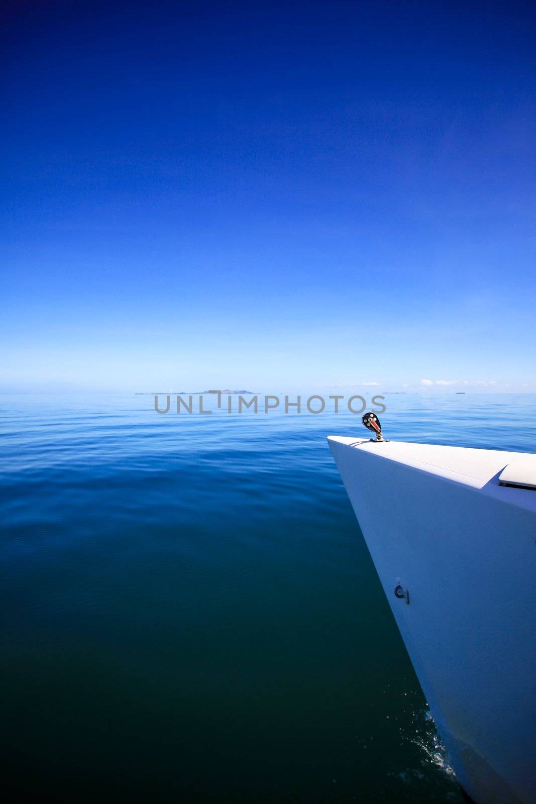 View of the bow of a sailing boat in calm blue sea.