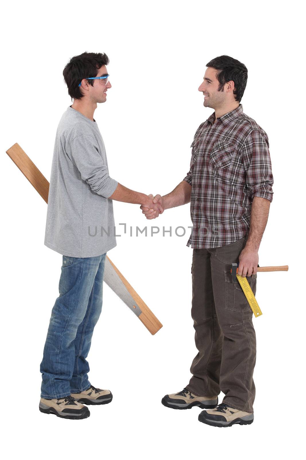 Two carpenters greeting each other by phovoir