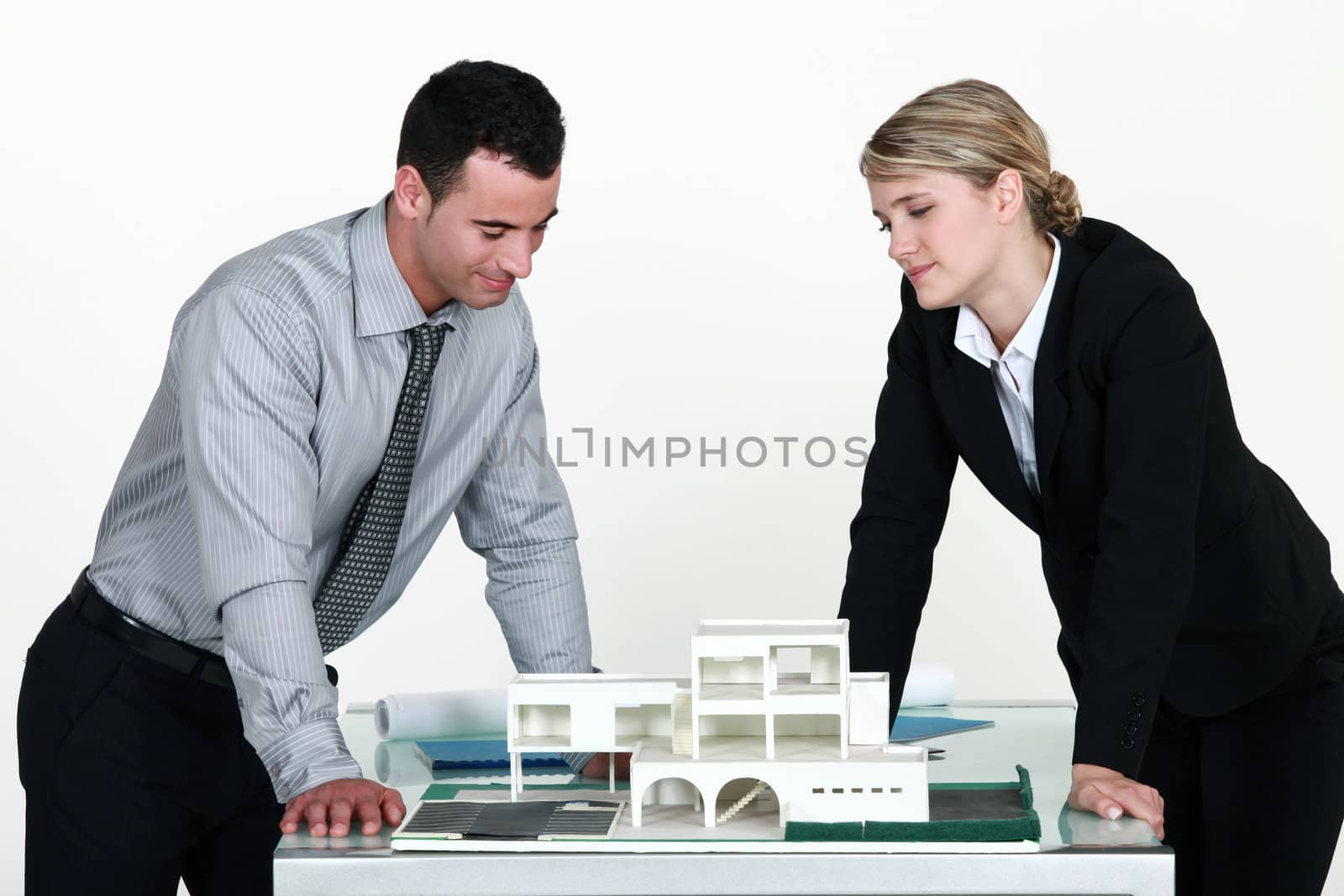 Architects looking at a 3D model by phovoir