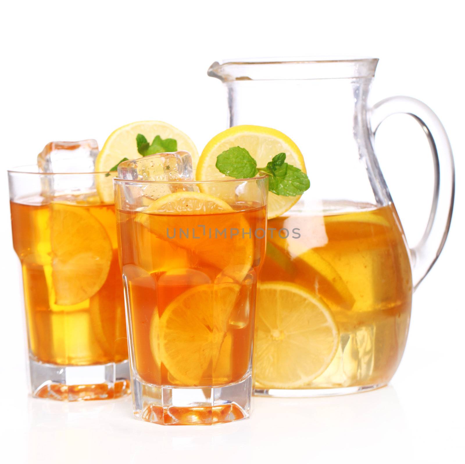 Fresh and cold ice tea with sliced lemon and mint