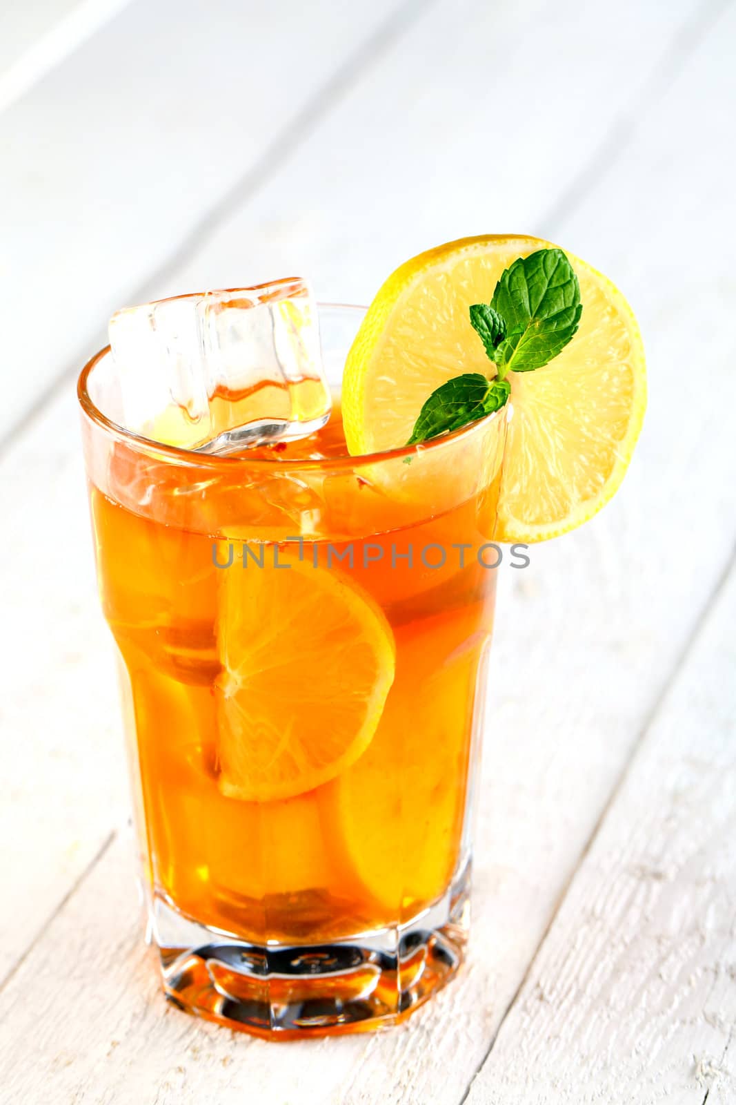 Fresh and cold ice tea with sliced lemon and mint