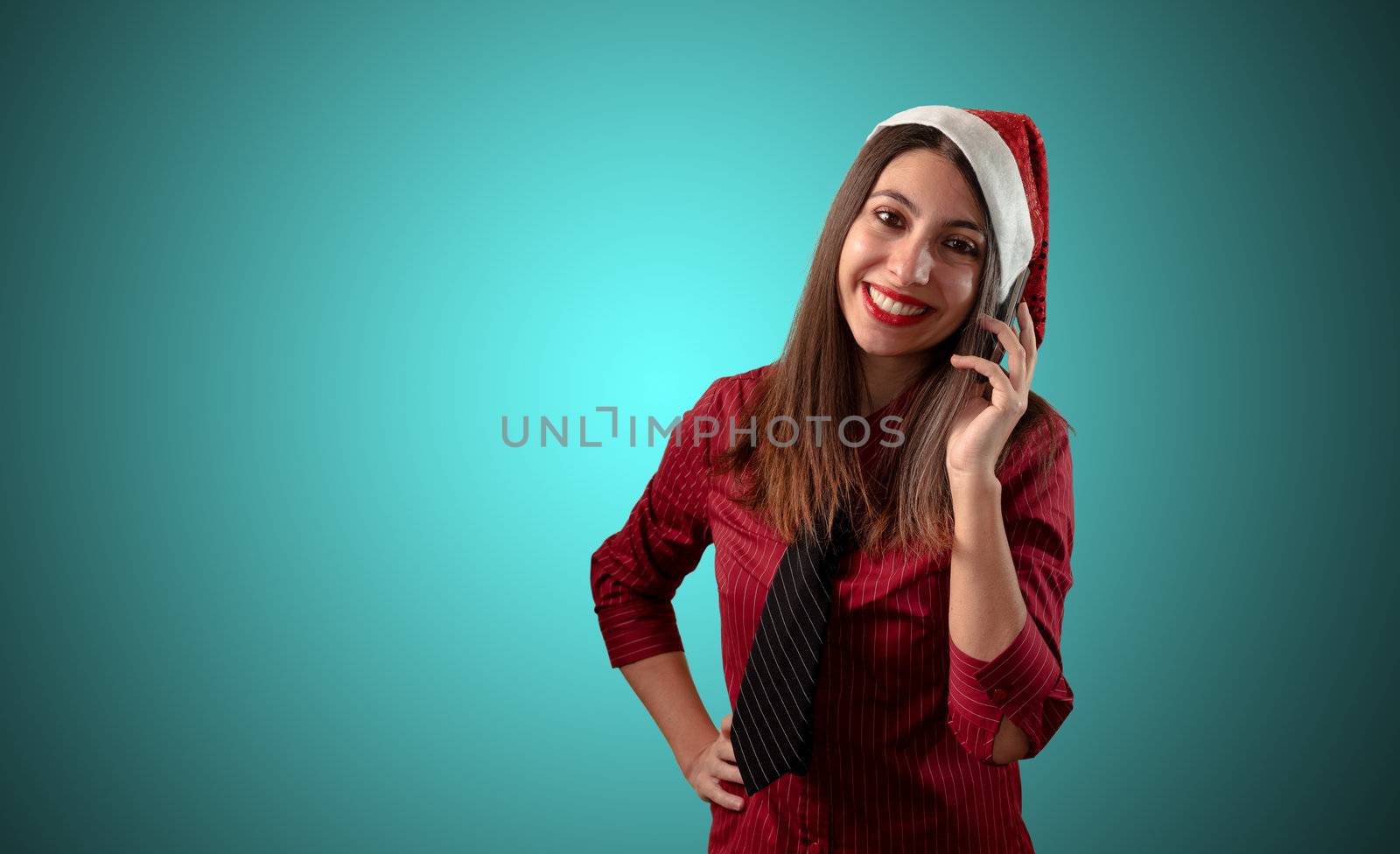 smiling business christmas girl at the phone on blue background