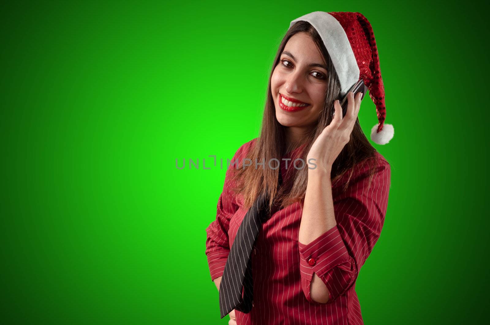 smiling business christmas girl at the phone on green background