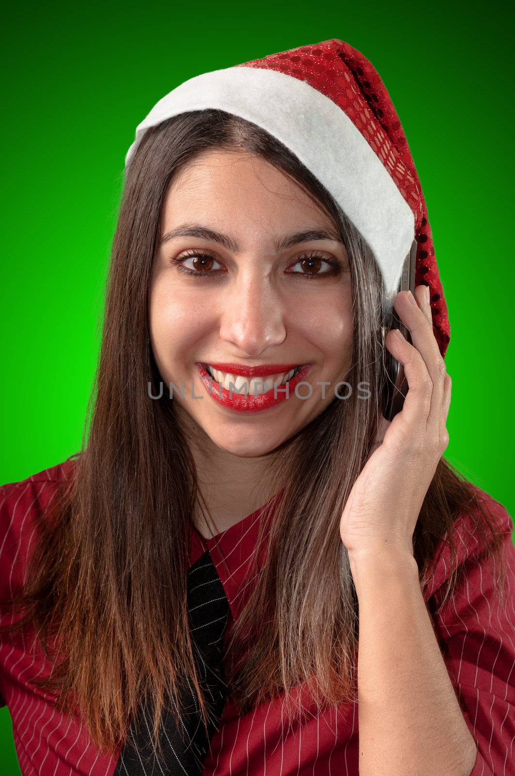 smiling business christmas girl at the phone on green background
