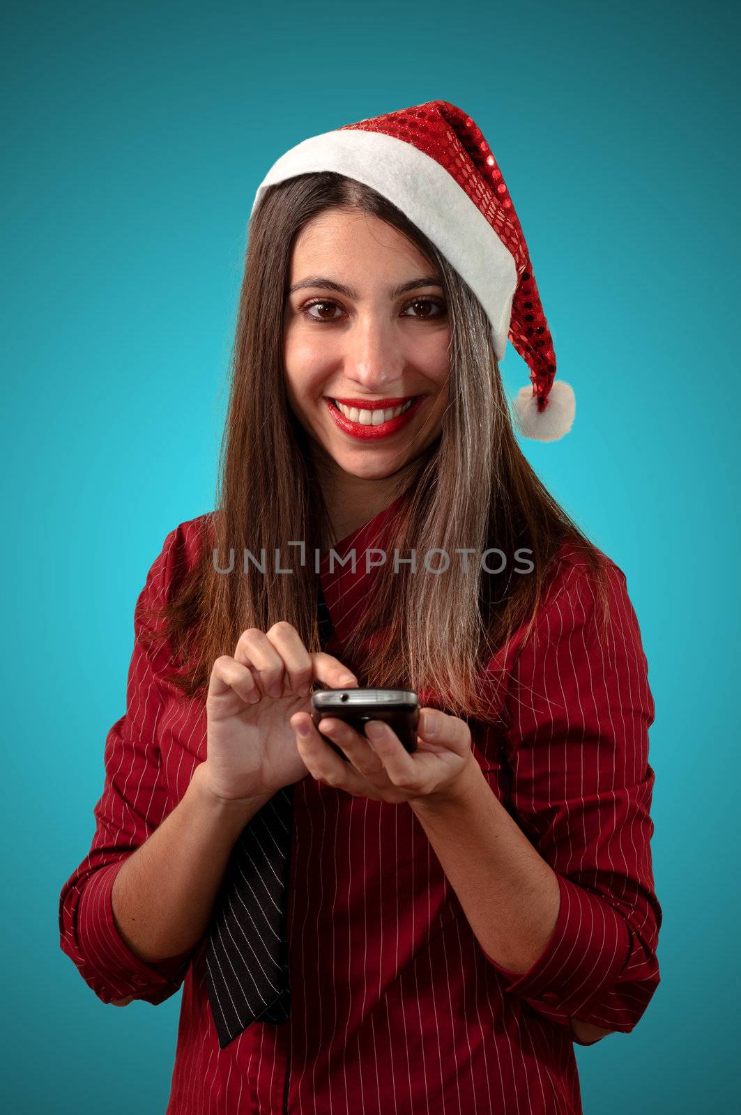 smiling business christmas girl at the phone on blue background