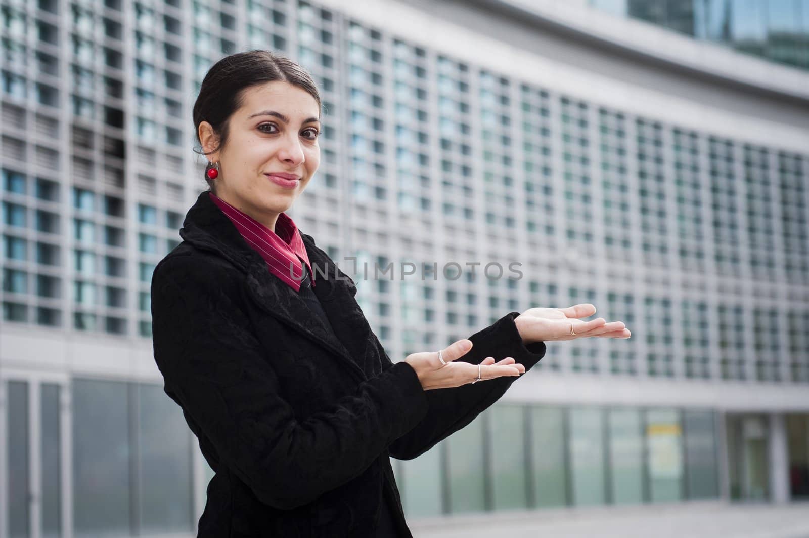 smiling business girl in front of a modern building