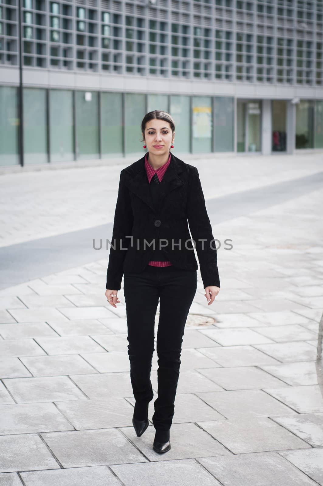 smiling business girl walking by peus