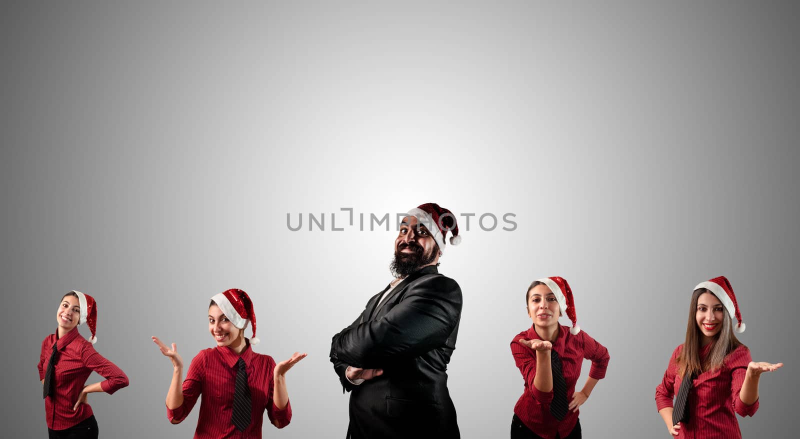 business santa claus and his christmas assistant girls on grey background