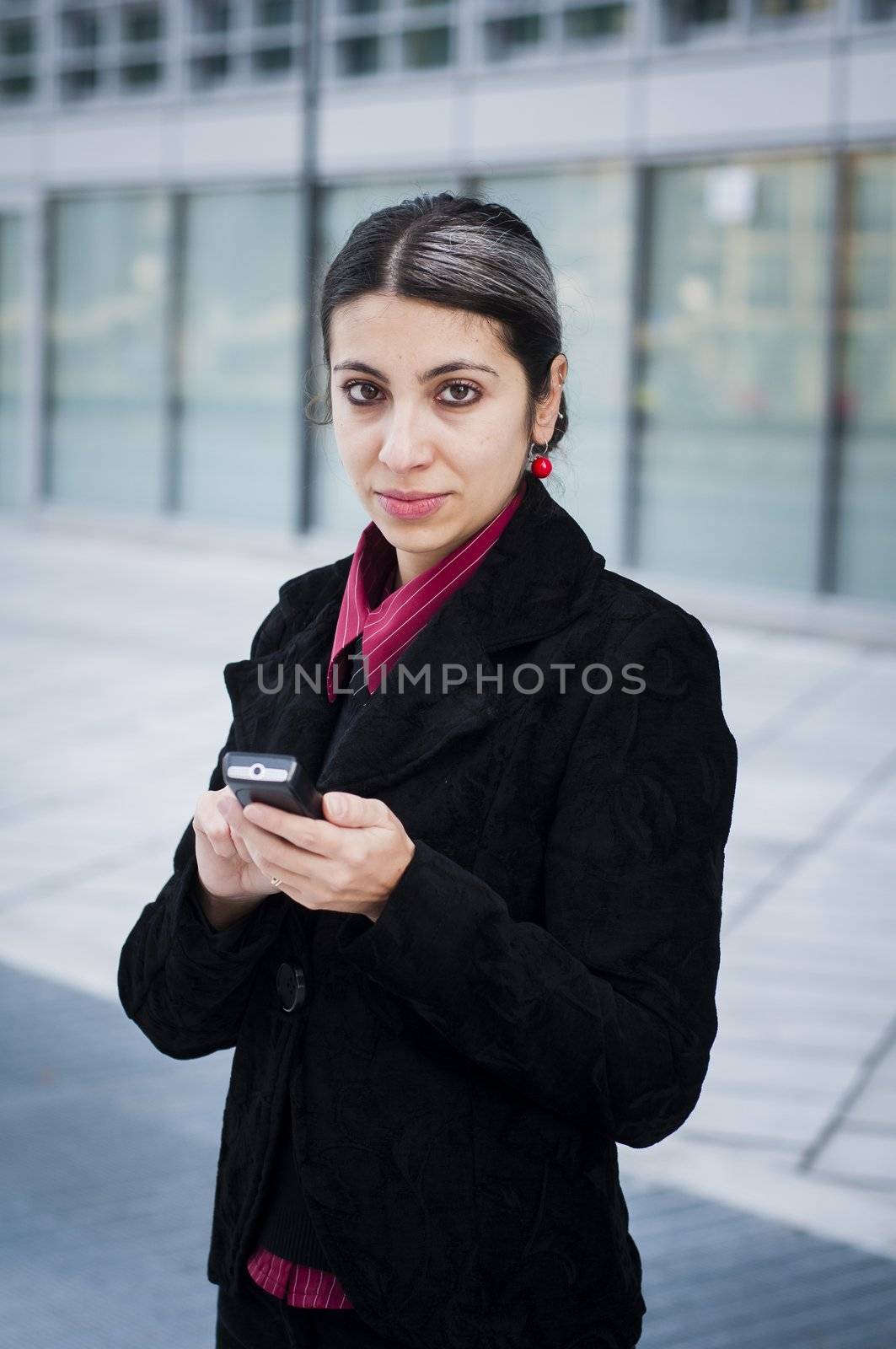 business girl on the phone in front of a modern building