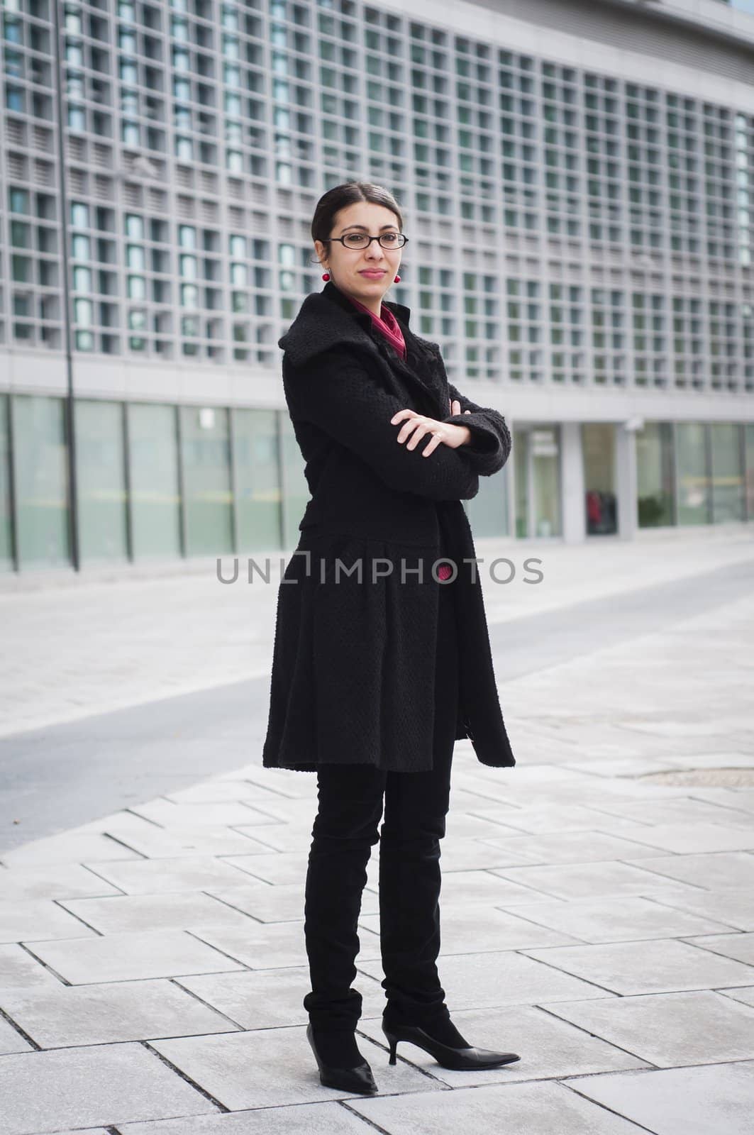 smiling business girl in front of a modern building