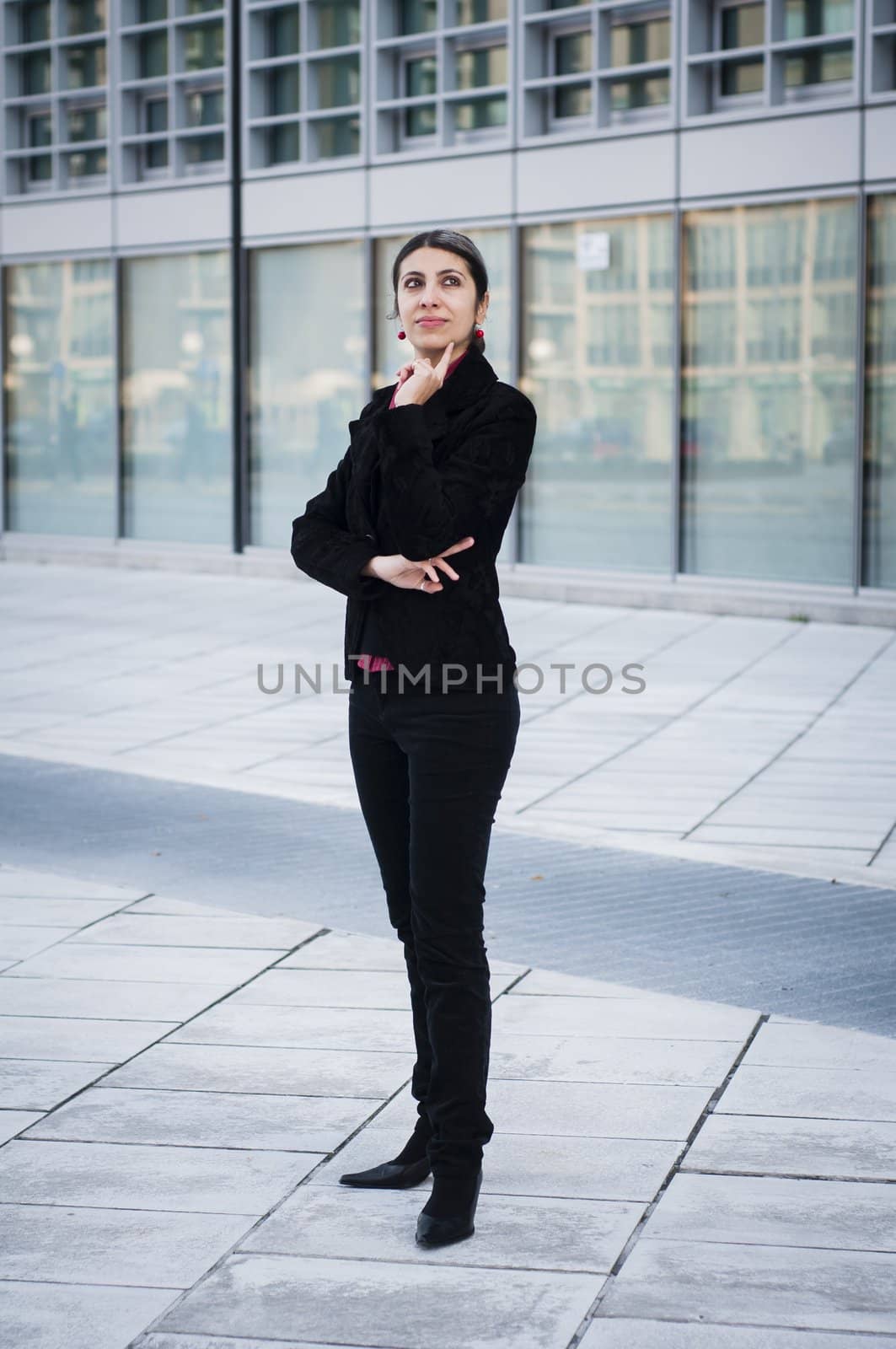 thinker business girl in front of modern building