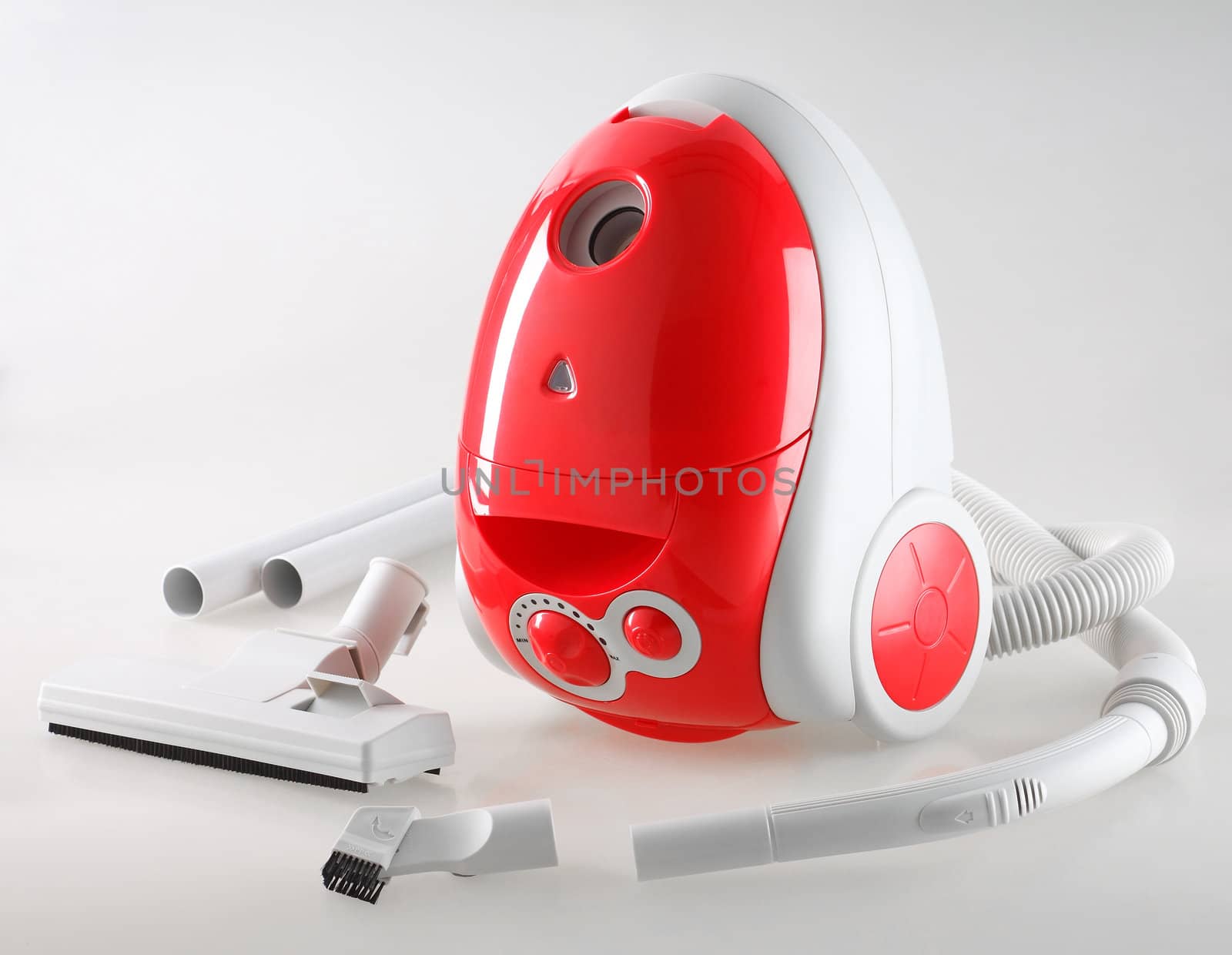 Red vacuum cleaner with accessories